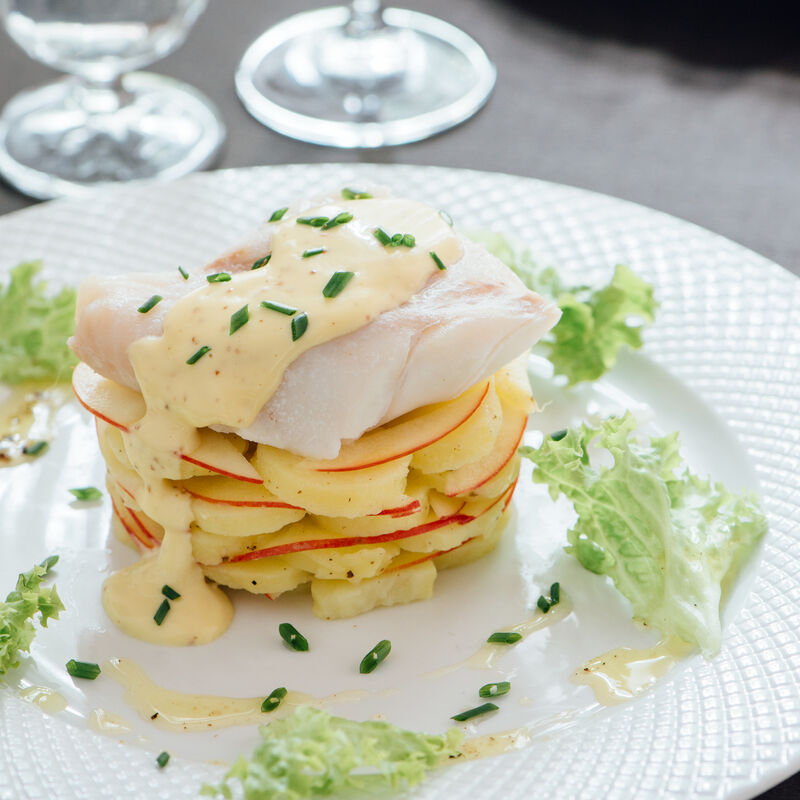 Skrei poché avec une mayonnaise à la moutarde sur une salade de pommes de terre tiède